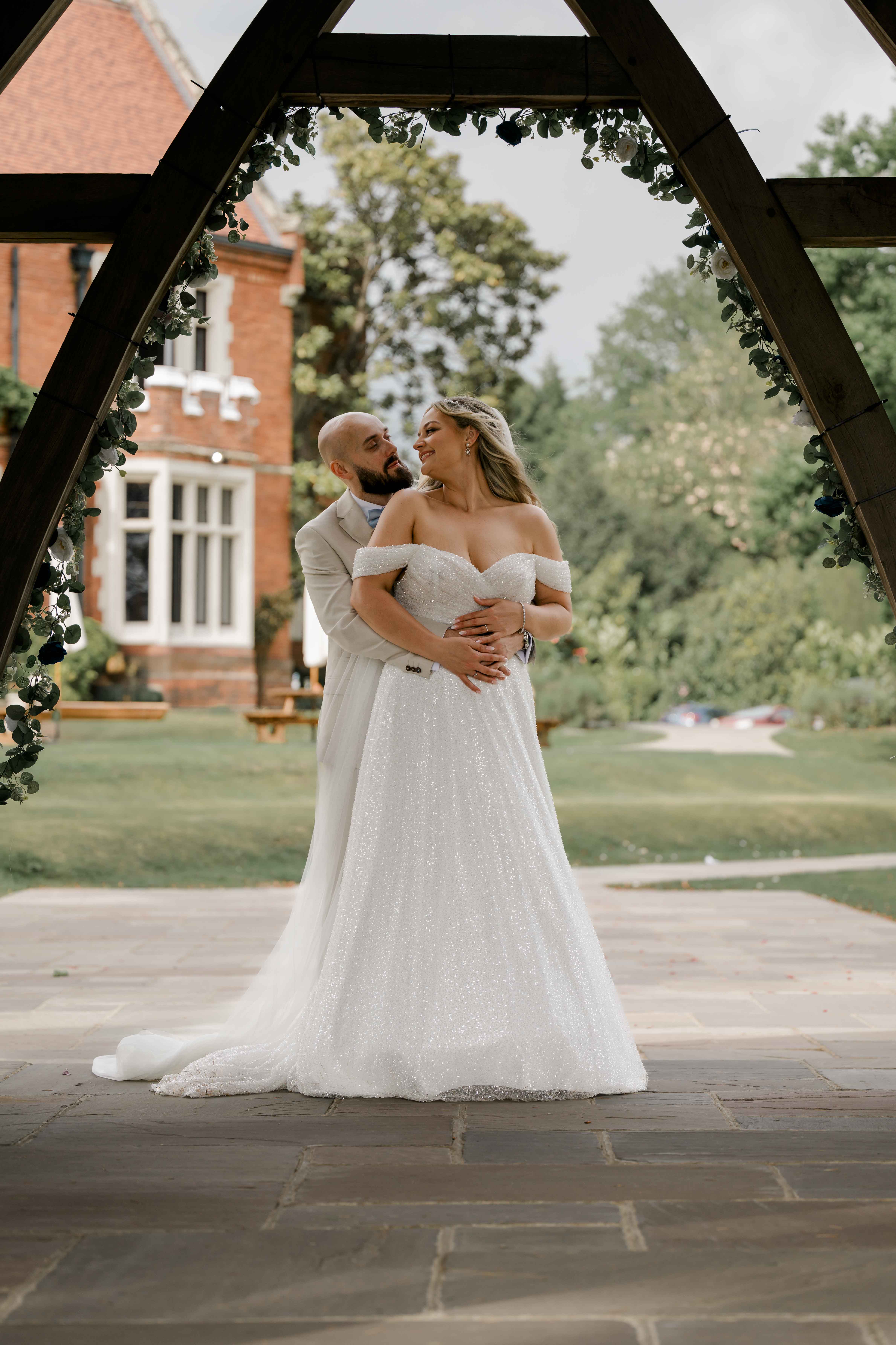 Wedding couple reviewing photographs, a wedding film and an album as parts of their complete wedding story