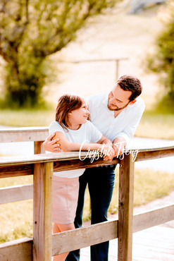 father and daughter smiling at each other_spring bridge photoshoot_Family Wall Portrait_family photographer_family photoshoot near me_outdoor photoshoot_Crystal Tseng Photography_Portrait Studio_Ellicott City_Baltimore_Maryland_Washington DC