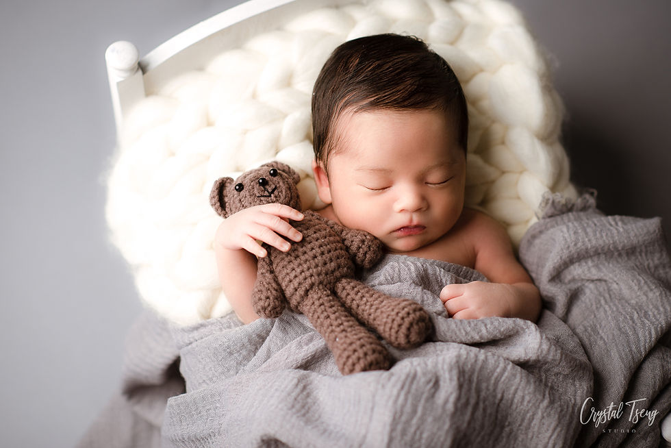 sleeping baby laying in small white bed hugging crochet bear_Ellicott City_Baltimore_Washington DC_Maryland newborn photographer_Crystal Tseng Photography Photo Studio_Baby Photographer_Newborn Photoshoot near me_Portrait Studio_Photo Studio