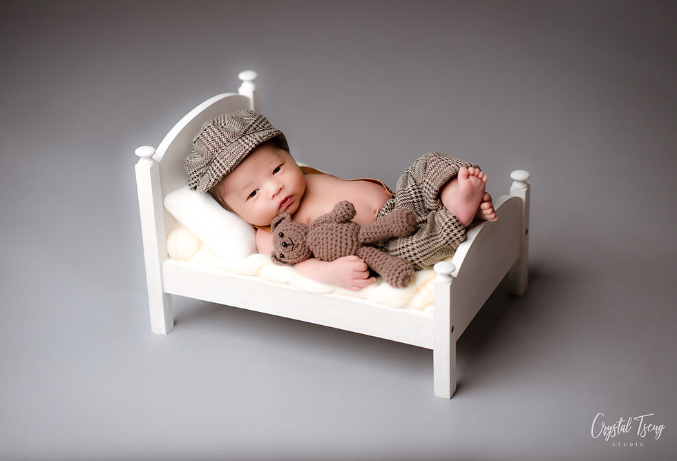 newborn baby in newsboy cap laying in small white bed_Ellicott City_Baltimore_Washington DC_Maryland newborn photographer_Crystal Tseng Photography Photo Studio_Baby Photographer_Newborn Photoshoot near me_Portrait Studio_Photo Studio