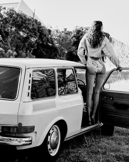 Woman entering vintage Volkswagen station wagon