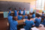 Wide angle view of a school building with children playing outside