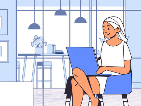 Woman in a white dress sitting in her living room using a laptop to search for internet service providers.