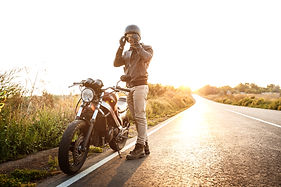 young-handsome-man-posing-near-his-motorbike-countryside-road.jpg