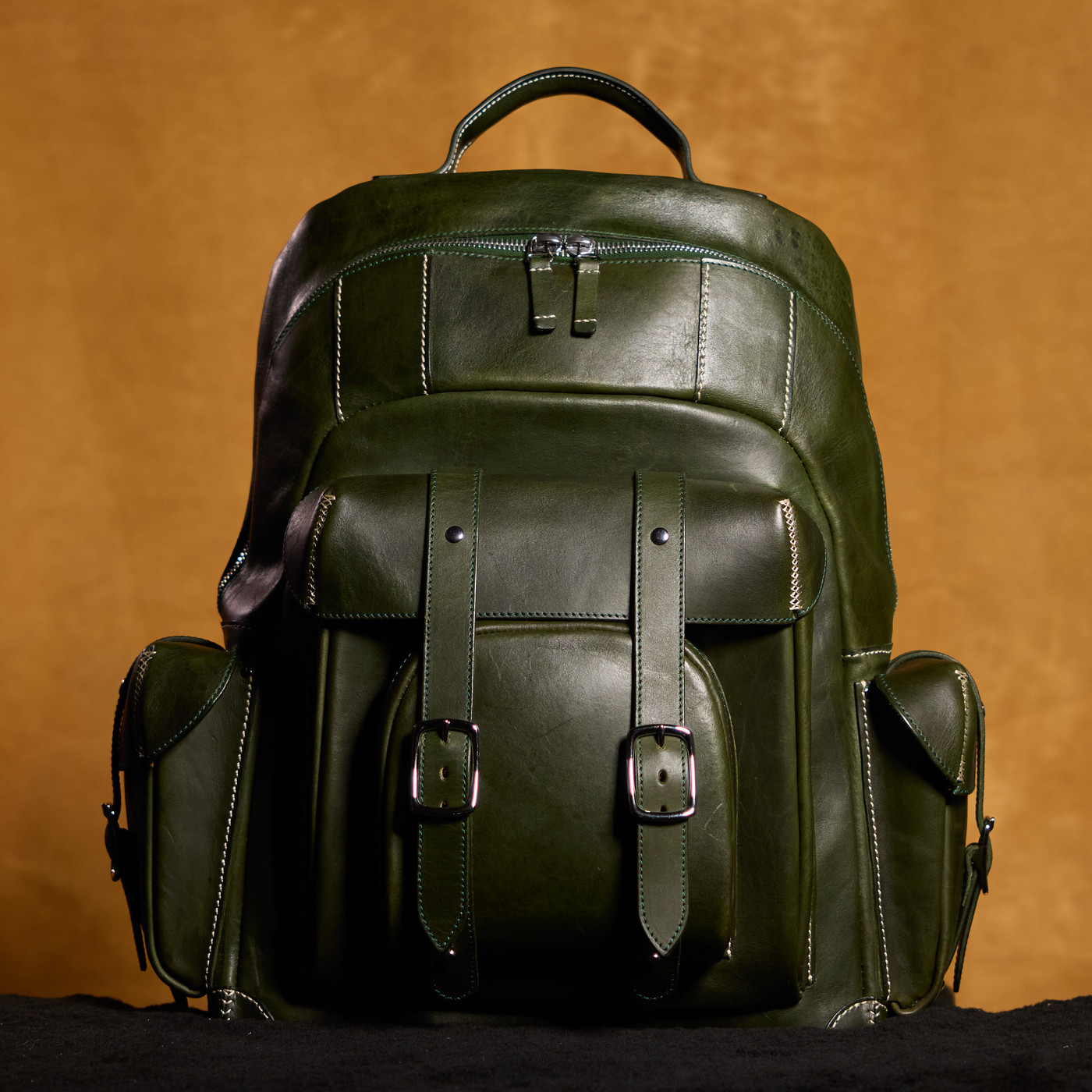 Hunter-Green backpack — three-quarter front view in outdoor light