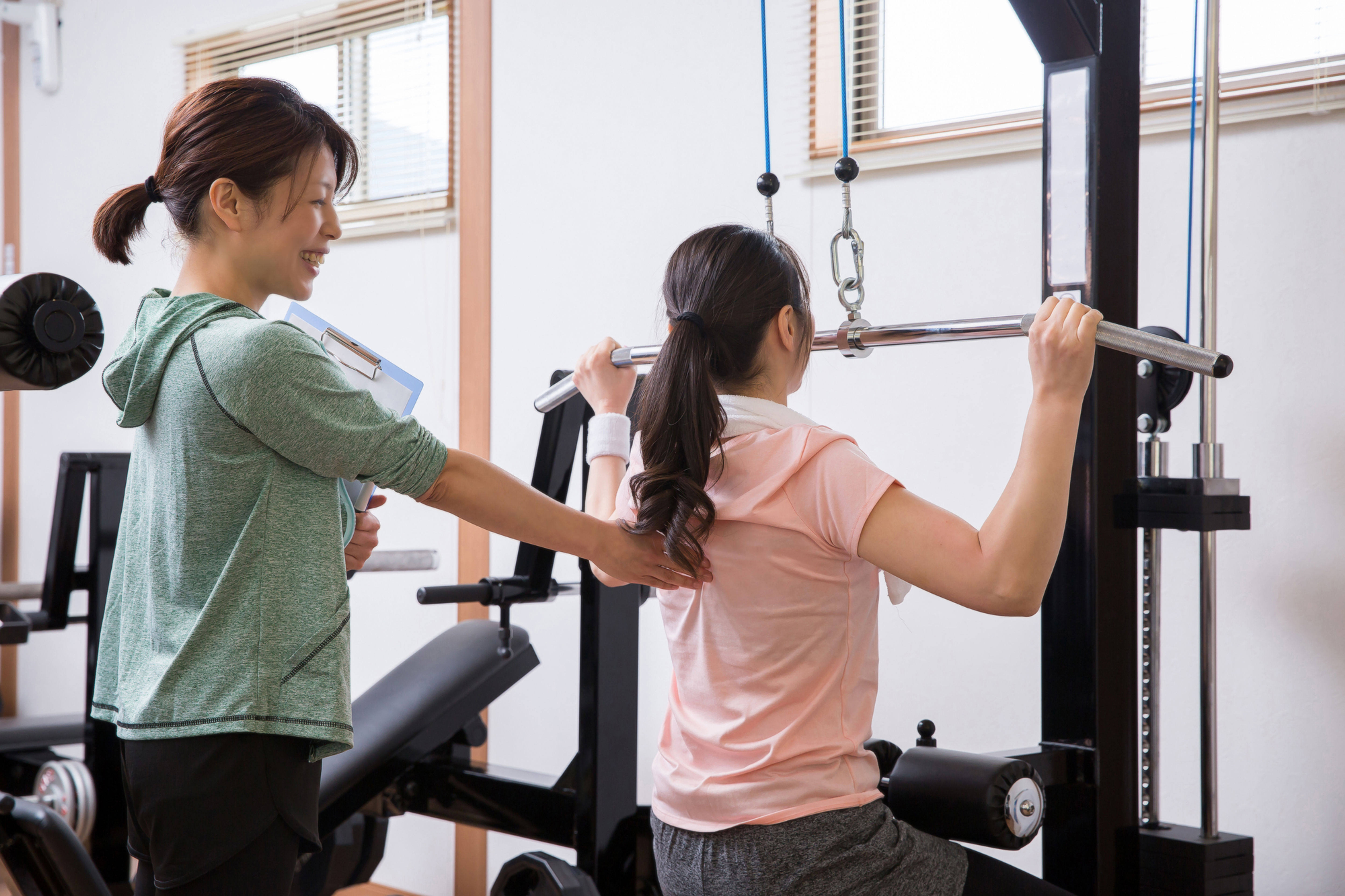 Personal training coaching client on how to do strength training