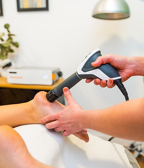 Unrecognizable patient undergoing modern therapy to reduce pain through shockwaves at a ph