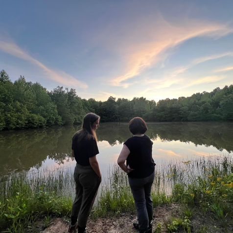 Michelle and Julie stand next to the pond to take in a sacred moment of witnessing life.