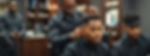 African American barber giving a fade haircut to a African American customer in upscale ba