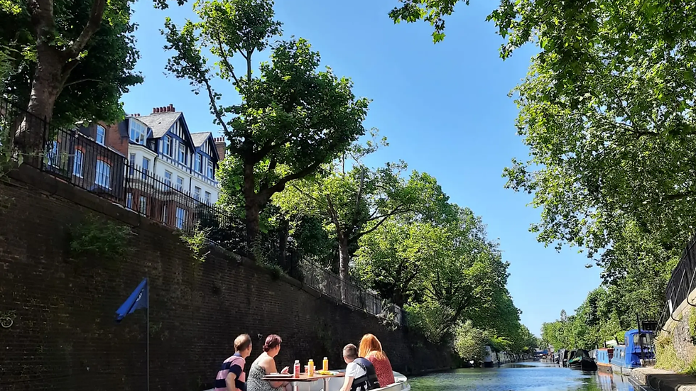 GoBoat London canal cruise: GoBoat London eco-friendly self-drive boat cruising canals with friends, snacks, and drinks, perfect for sunny group or date outings with waterside views.
