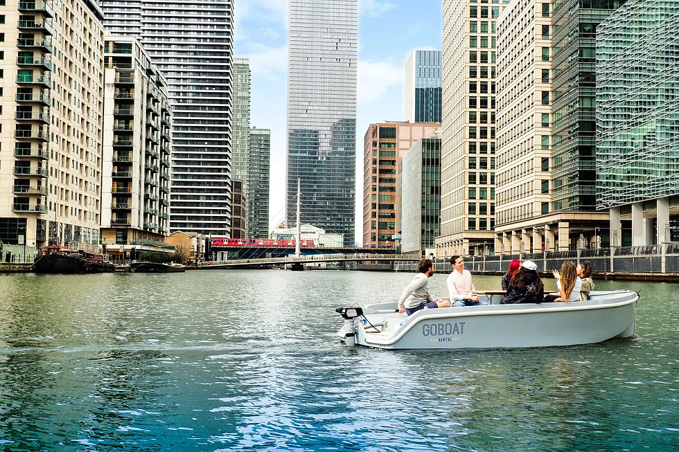 GoBoat London canal cruise: GoBoat London self-drive boat with friends paddling and picnicking along canals, ideal for sunny social catch-ups in the city.