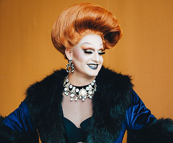 A Portrait of Odette Hella'Grand on a yellow backdrop