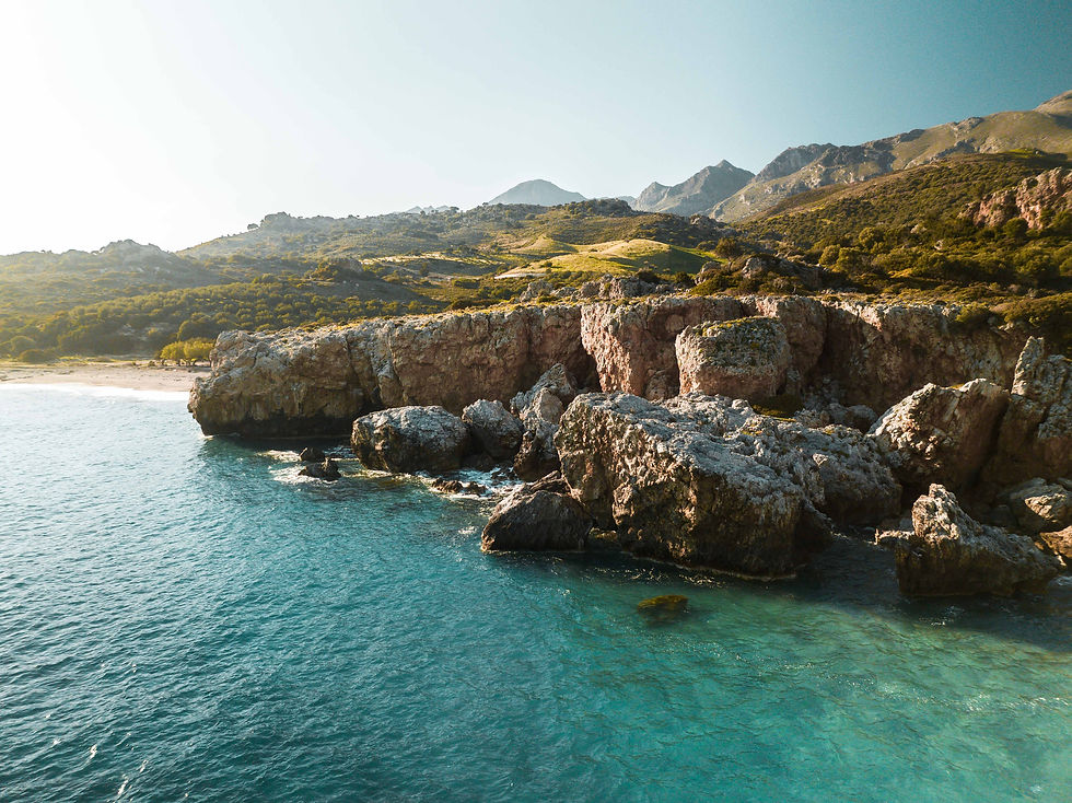 Scenic view of a beach, sea, and mountains in Crete.