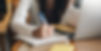 Woman writing notes in notebook
