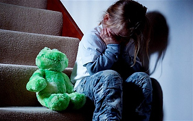 child sitting on stairs with head in her hands.png
