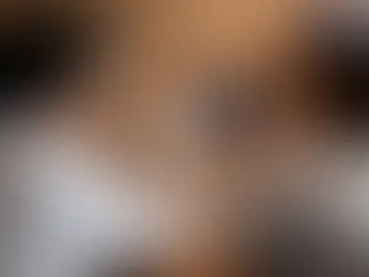 A group of office workers seated around a desk or conference table are looking at charts and graphs displayed.