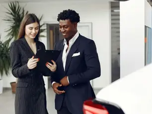 A man and a women in suit are discussing something while standing