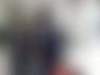 A man and a women in suit are discussing something while standing