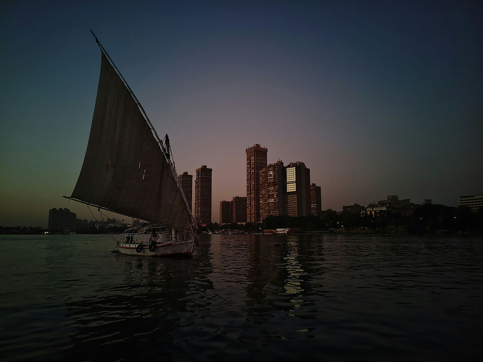 Felucca on the Nile in front of the Cairo skyline in the evening