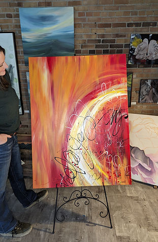Local North Idaho artist Hannah Sucsy Teascarlet looks at her finished abstract art commission piece "Kindle" 