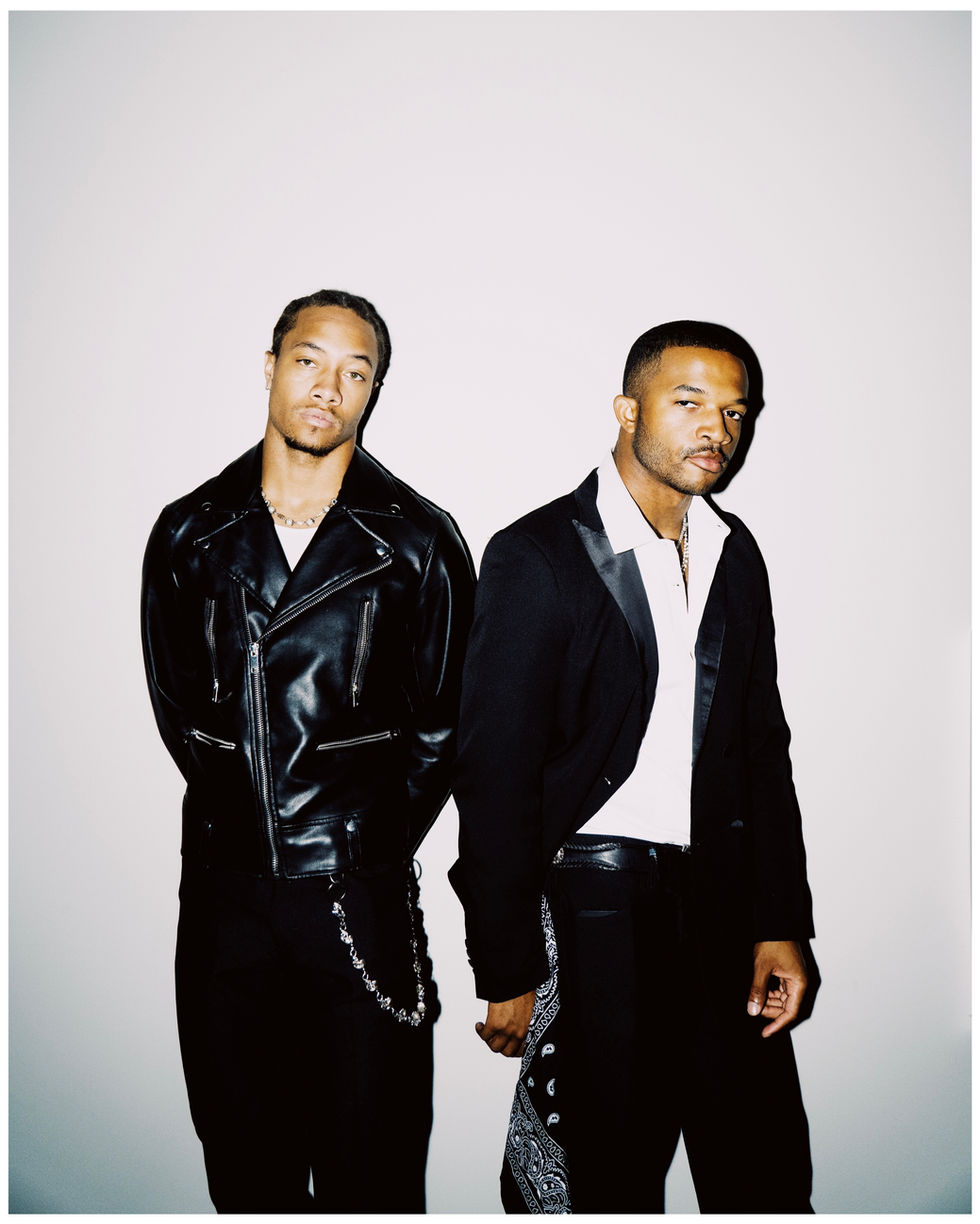 Two men in formal attire posing and looking at the camera.