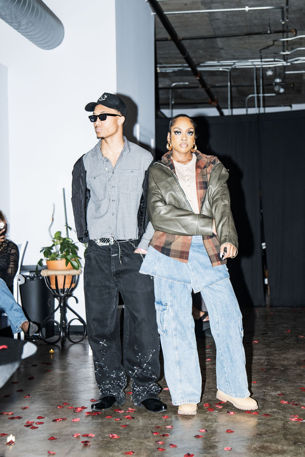 Two people posing for a photo at a fashion show event.