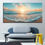 Thumbnail: Beach Sunset Canvas Wall Art over a blue one-arm couch in a minimalist styled room