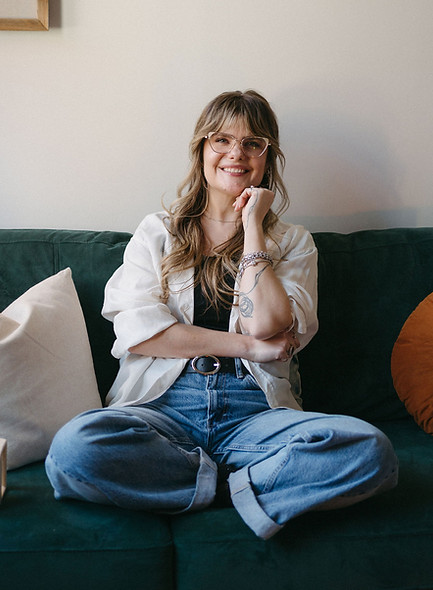 Stephanie Orr smiling while sitting on her therapy couch 