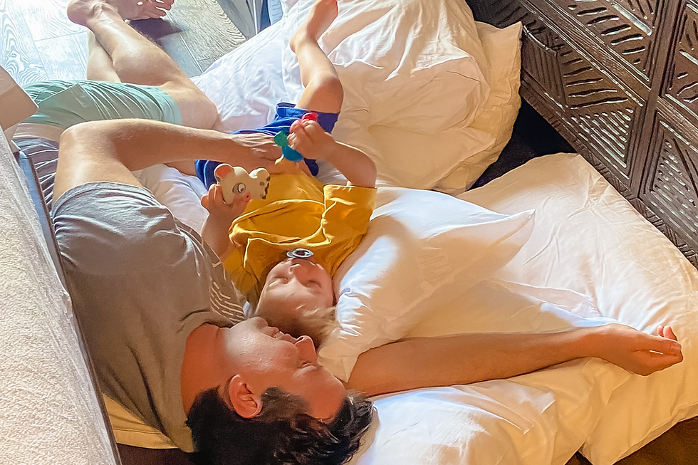 toddler and dad laying on the floor at Disney Resort