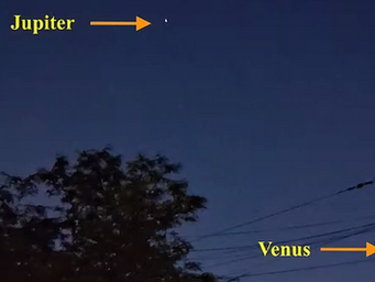 Twilight street scene with labeled Jupiter, Venus, and crescent Moon above houses, trees, and power lines. It is notable how close planets and the Moon appear in the sky especially Venus and the Moon.