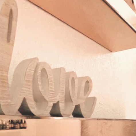 the word "love" on a mirrored shelf