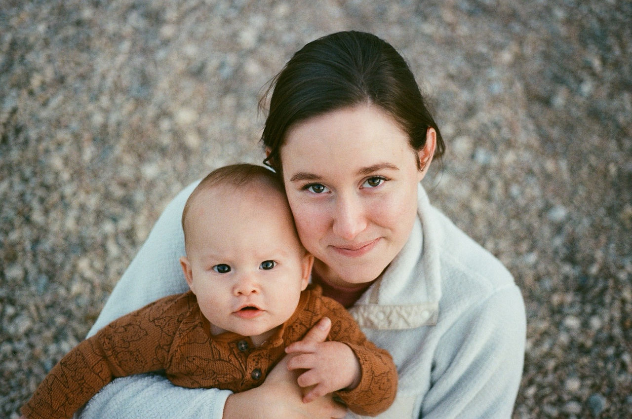 Portrait of a woman and child with pebbles in background 