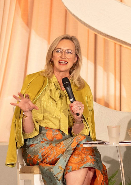 Photo of Laura Cox Kaplan speaking with microphone