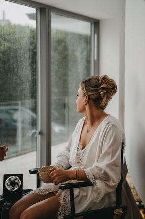 Wedding morning, bride, bride looking out in the window 