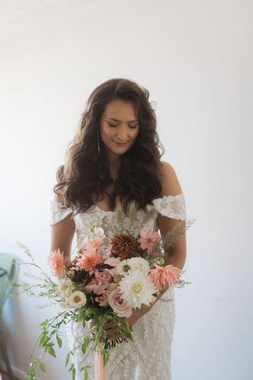 Portrait of the bride looking down on her flowers 