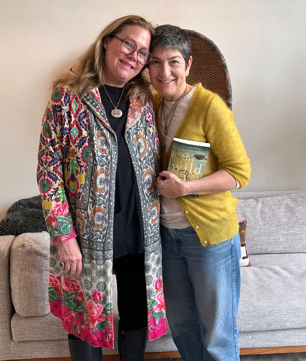 Author Laura Munson & ALTAR Founder Kathy Bresler standing together and smiling. Kathy is holding Laura's book, The Wild Why."