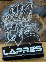 A white LED lasercut badge of Lapres a dragon