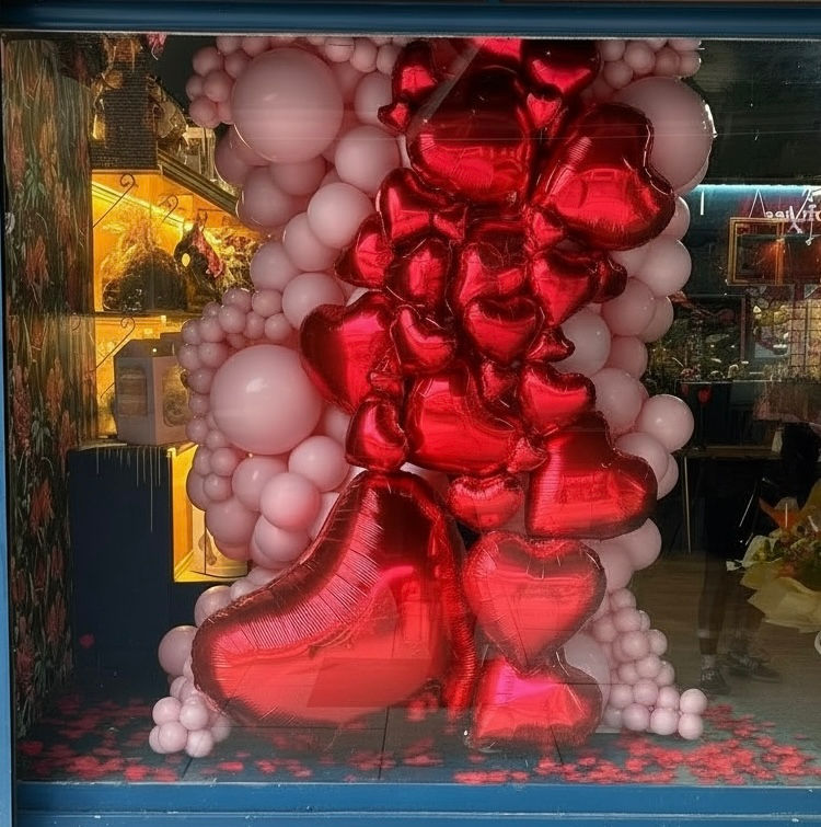 Valentine's Day Window display created with high quality balloons and Red foil heart balloons.