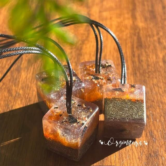 Miniatura: Orgonite em formato de dadinhos feitos com resina, metal e cristais de turmalina negra e quartzo