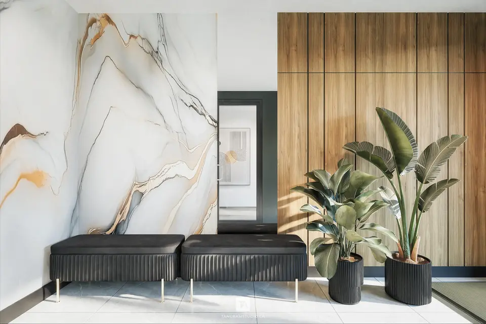 Rendu 3D photoréaliste d’un lobby résidentiel moderne, avec mur en pierre naturelle, panneaux en bois, assises contemporaines, végétation intégrée et éclairage doux, réalisé par Tangram Studio.