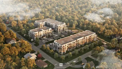 Rendu 3D photoréaliste d’un projet résidentiel multifamilial à Saint-Jérôme, vue aérienne de l’implantation des bâtiments dans leur environnement naturel, avec intégration paysagère et contexte urbain, réalisé par Tangram Studio.