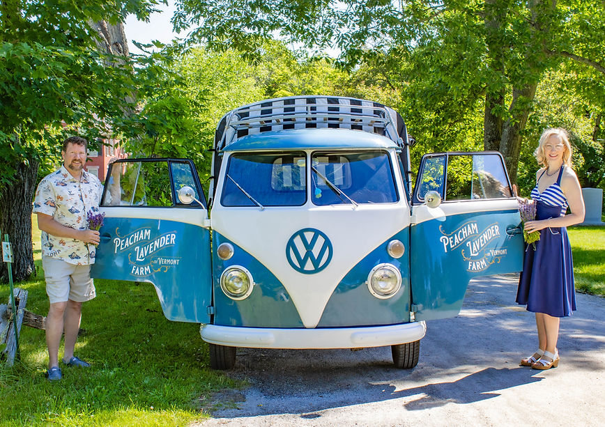 Couple standing with Ringo the blue and white flower truck.