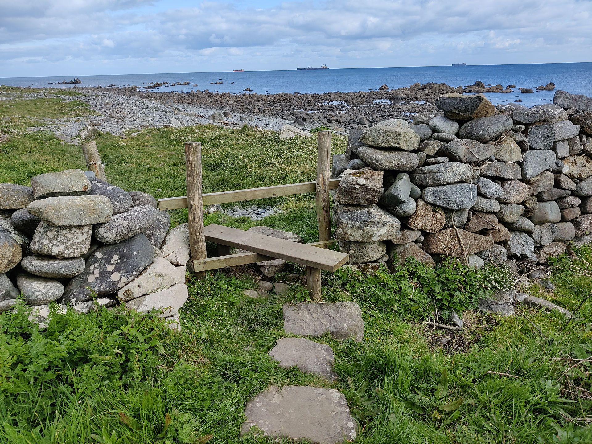 Wooden stile through wall on coast path