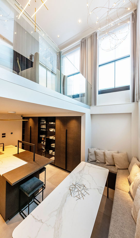 Conversion and refurbishment of a former office building in central London to create a bespoke four-bedroom family home, including a basement kitchen and mezzanine living space.