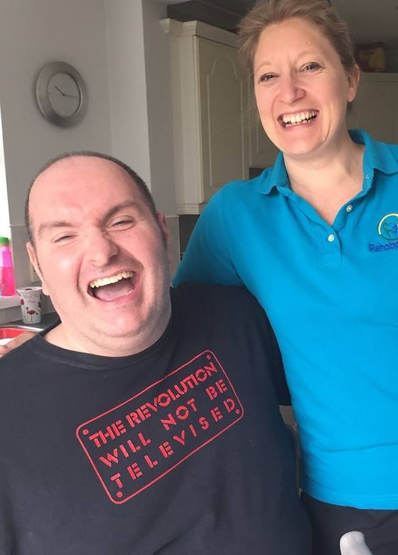 Lady physiotherapist with a man who is laughing.jpg