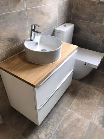 Modern toilet and sink with wooden unit
