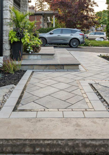 Premium stone paver walkway installation leading to a residential front entrance.