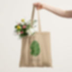 Minimalist beige tote bag featuring a detailed botanical illustration of a green primrose leaf with elegant text.