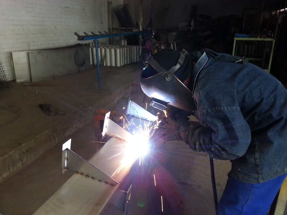 Welder at G-Tech Steel using a torch for metal fabrication