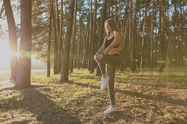gorgeous-female-runner-doing-stretching-exercise-workout-wood-sun_edited.jpg